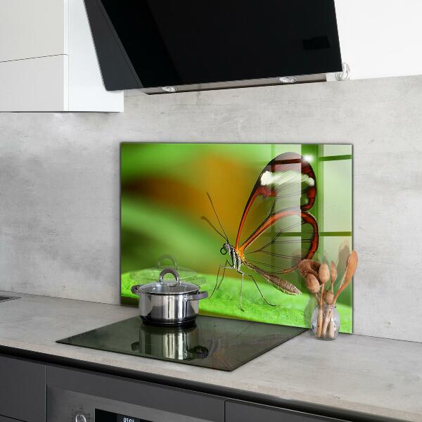 Keuken achterwand glas Vlinder op een blad